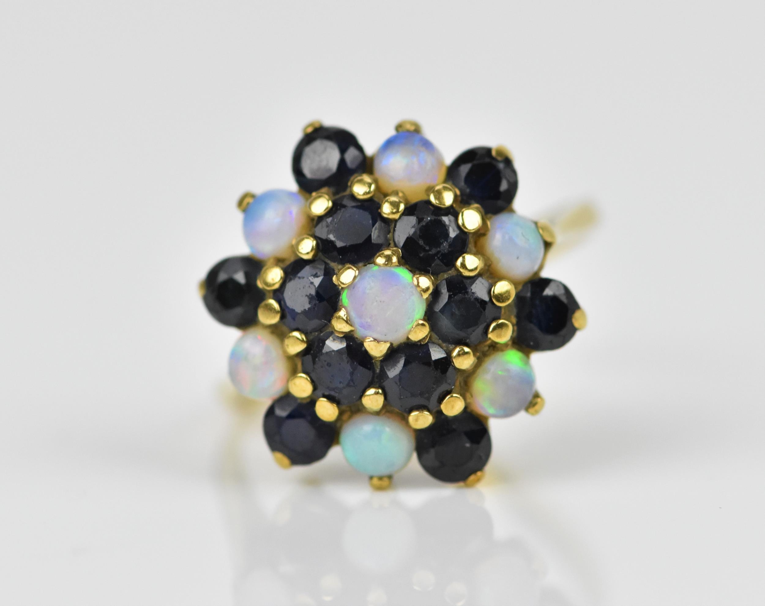 A yellow metal, blue sapphire and water opal dress ring, with cluster design of alternating cabochon