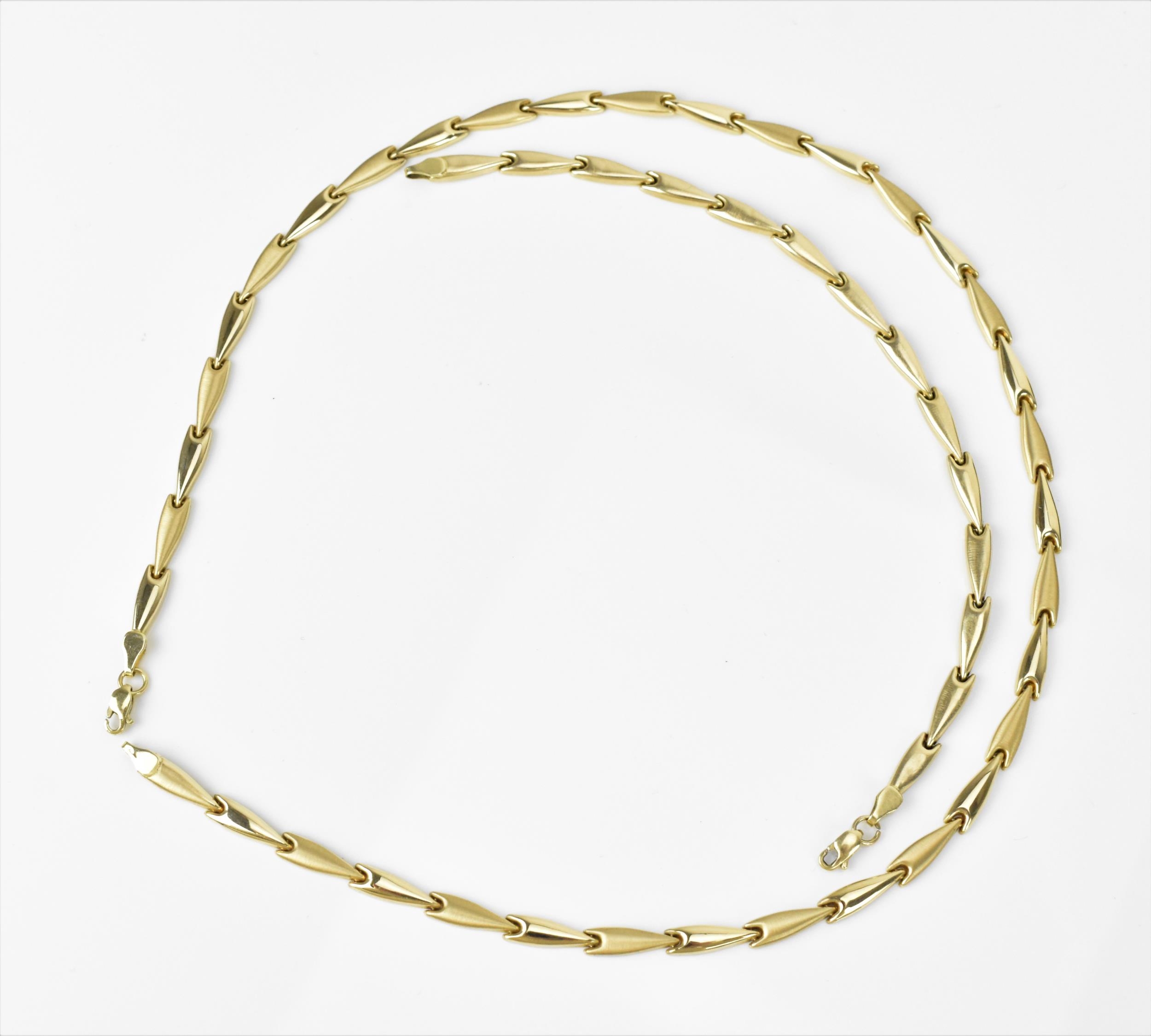 A 14ct yellow gold matching necklace and bracelet, with arrow style links alternating in satin and