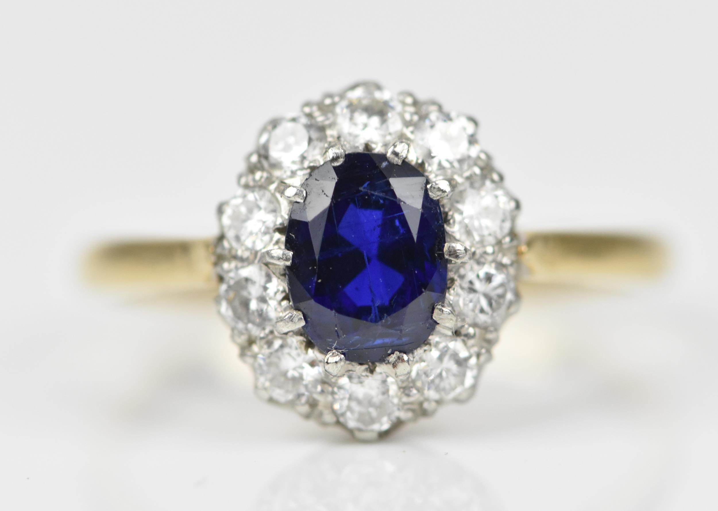An 18ct yellow gold, sapphire and diamond cluster ring, with central oval cut blue sapphire in a - Image 2 of 6