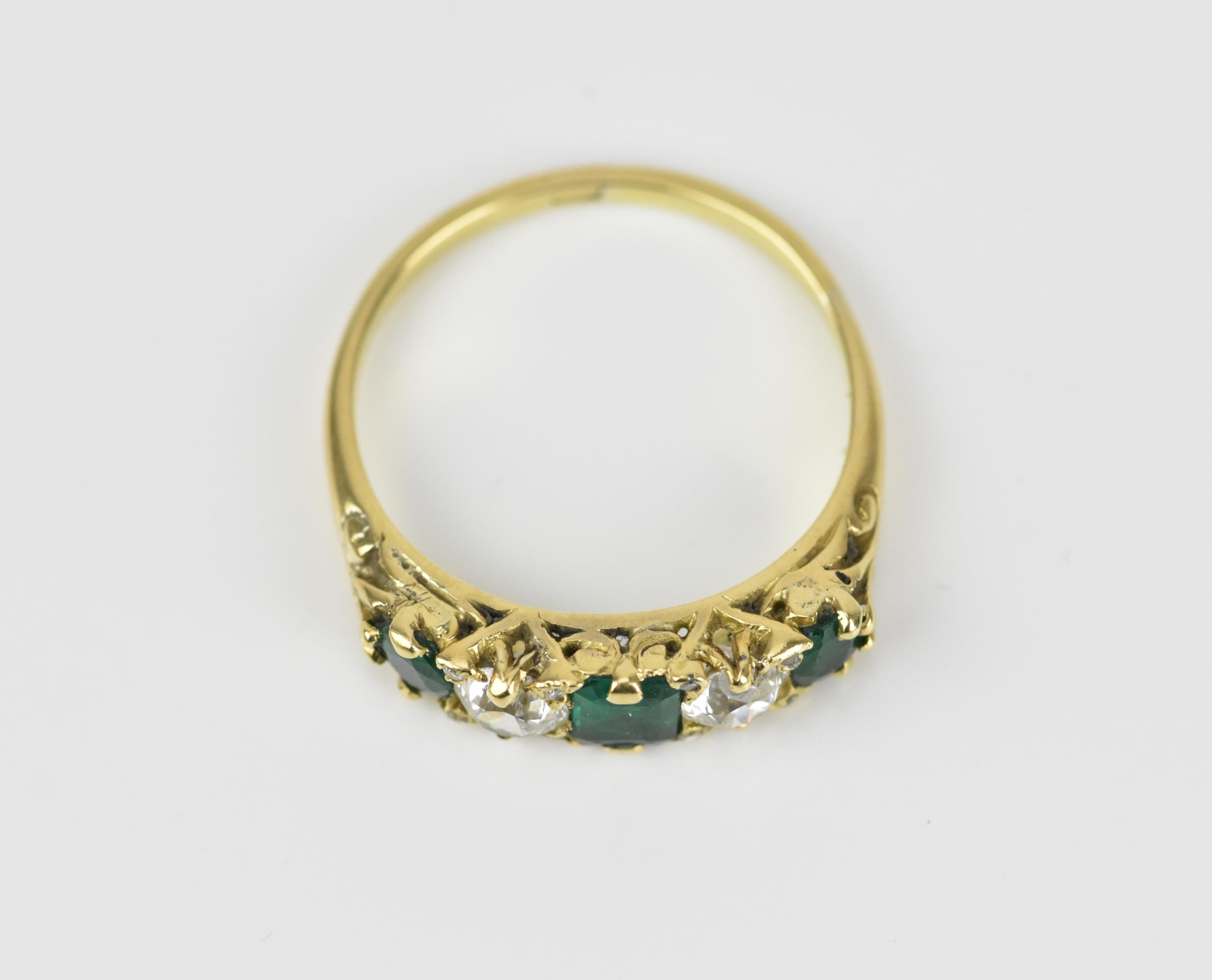 A yellow metal, diamond and emerald five stone ring, set with central octagon cut emerald flanked - Image 5 of 6