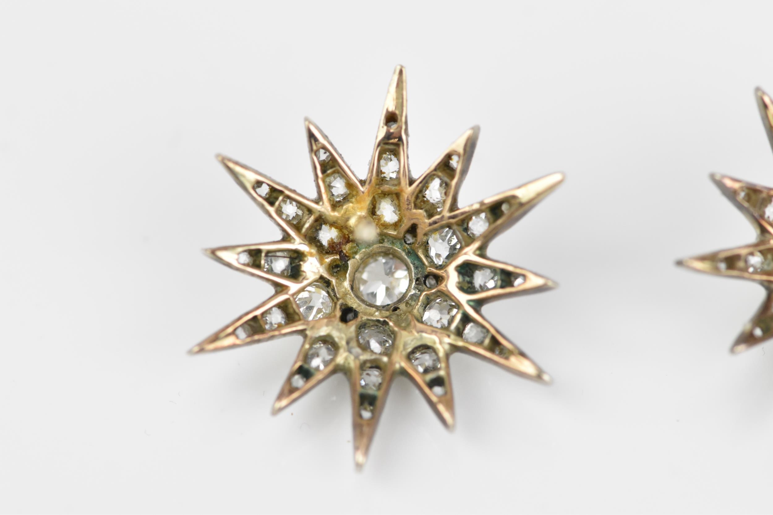 A pair of early 20th century white metal and diamond starburst earrings, set with old mine cut - Image 8 of 9
