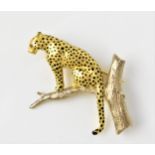 An 18ct gold leopard brooch, by Harriet Glen, inset with ruby eyes and applied with enamel spots