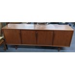 A mid 20th century Gumi Omann for Axel Christensen, Denmark, teak sideboard having four sliding