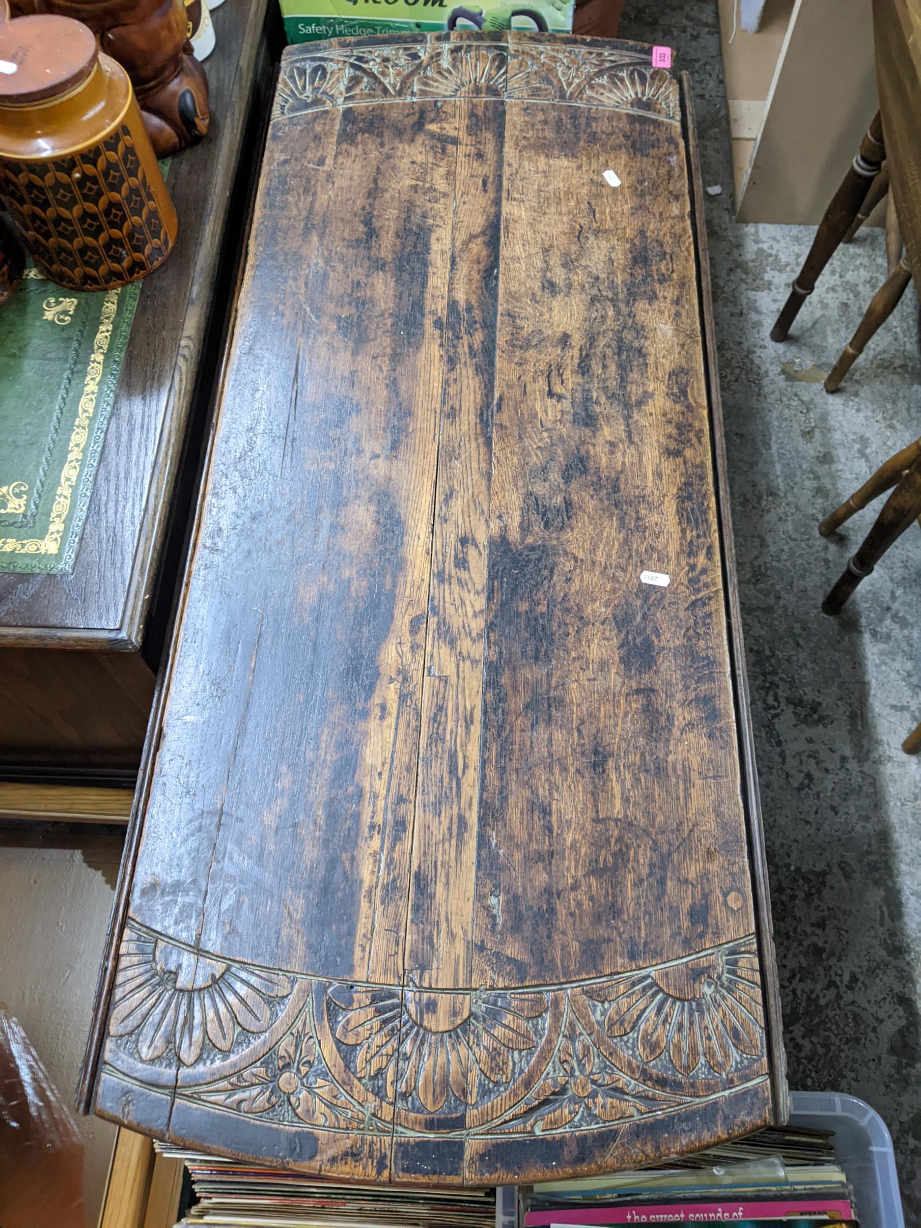 A Victorian carved oak gateleg table, the top with a band of stylised floral decoration, on turned - Image 2 of 3