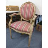 A reproduction French style side chair having a painted carved frame, oval back and reeded legs