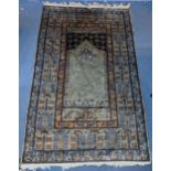 A hand woven green ground Middle Eastern rug A/F having floral design repeating and tasselled ends