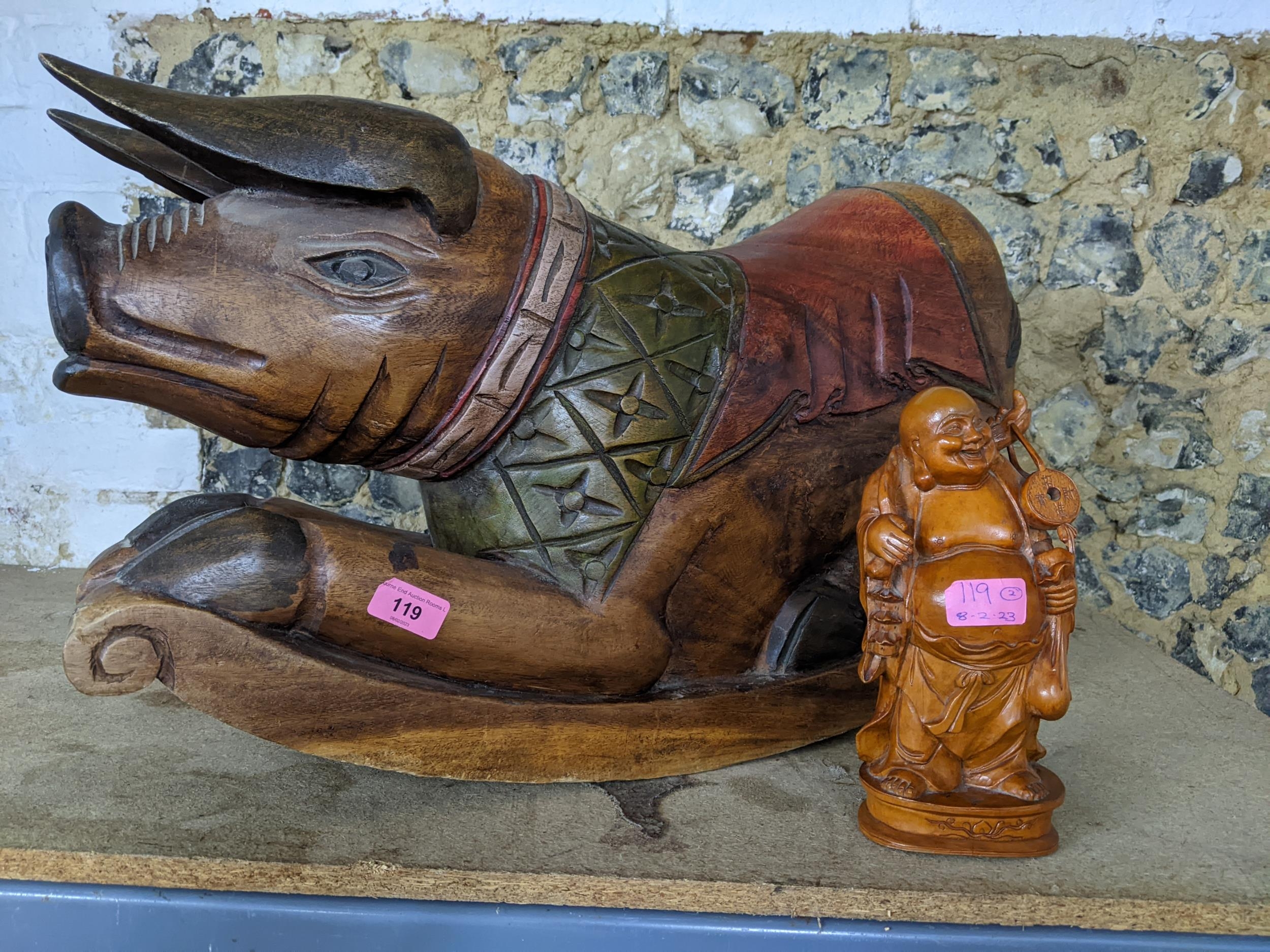 A modern Indonesian carved wooden rocking pig and a Chinese hardwood figure Location: