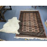 A Middle Eastern handwoven rug having multiguard borders and repeating elephant foot motifs 186cm