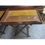 An early 20th century mahogany butlers tray on folding stand Location: