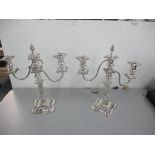 A pair of silver plated three-branch candelabra 40cm x 34cm Location: