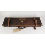 A brass-bound leather gun case by Holland & Holland, London, for hammerless ejector gun, the case of