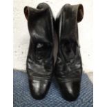 A pair of Edwardian gent's black leather ankle boots with button fastening, UK size 10.5, one button