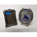Two early 20th century silver photograph frames, one oval in shape standing on ball feet and easel