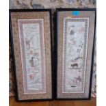 A pair of 20th Century Chinese cream silk panels with embroidered images of temples, water