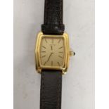 A Longines 9ct gold ladies manual wind wristwatch having a gilt dial with baton markers and on a