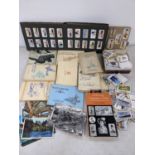 A collection of cigarette cards in albums and loose, together with postcards