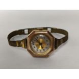 A 1920's 9ct gold ladies manual wind watch in octagonal case and on a gold plated bracelet Location: