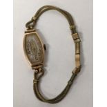 A 1930's ladies manual wind watch on a gold plated rope twist bracelet Location:
