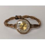 An early 20th century 9ct gold ladies manual wind watch on a 9ct gold expanding bracelet, 19.4g