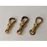 A pair of 9ct gold pocket watch chain dog clip clasps, 3.2g and a 15ct gold clip, 2.6g Location: