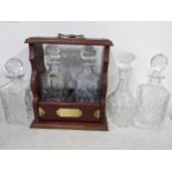 A Tantalus with two Royal Brierley decanters, together with three other loose decanters Location: