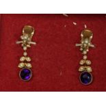 A pair of yellow metal earrings inset with amethyst and seed pearls, total weight 5.1g Location: