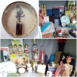 A mid 20th century household lot comprising tins, travel and bedside clocks, dolls of the world,