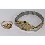 A 9ct gold ladies watch on a later expanding bracelet together with a yellow metal ring, 3.1g, total