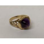 A 9ct gold ring with pierced shoulders and inset with a large amethyst, 4.6g Location: