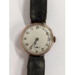 A 1920's 9ct gold gents manual wind watch on a black leather strap, hallmarked London 1924 Location: