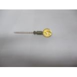 A yellow metal 1861 large Indian head dollar mounted on a stick pin Location: