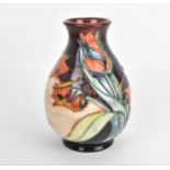 A Moorcroft pottery vase designed by Sally Tuffin, in the 'Red Tulip' pattern, of baluster form with
