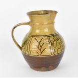 Michael Cardew CBE (1901-1983) British, a Winchcombe pottery slipware jug, of baluster form with