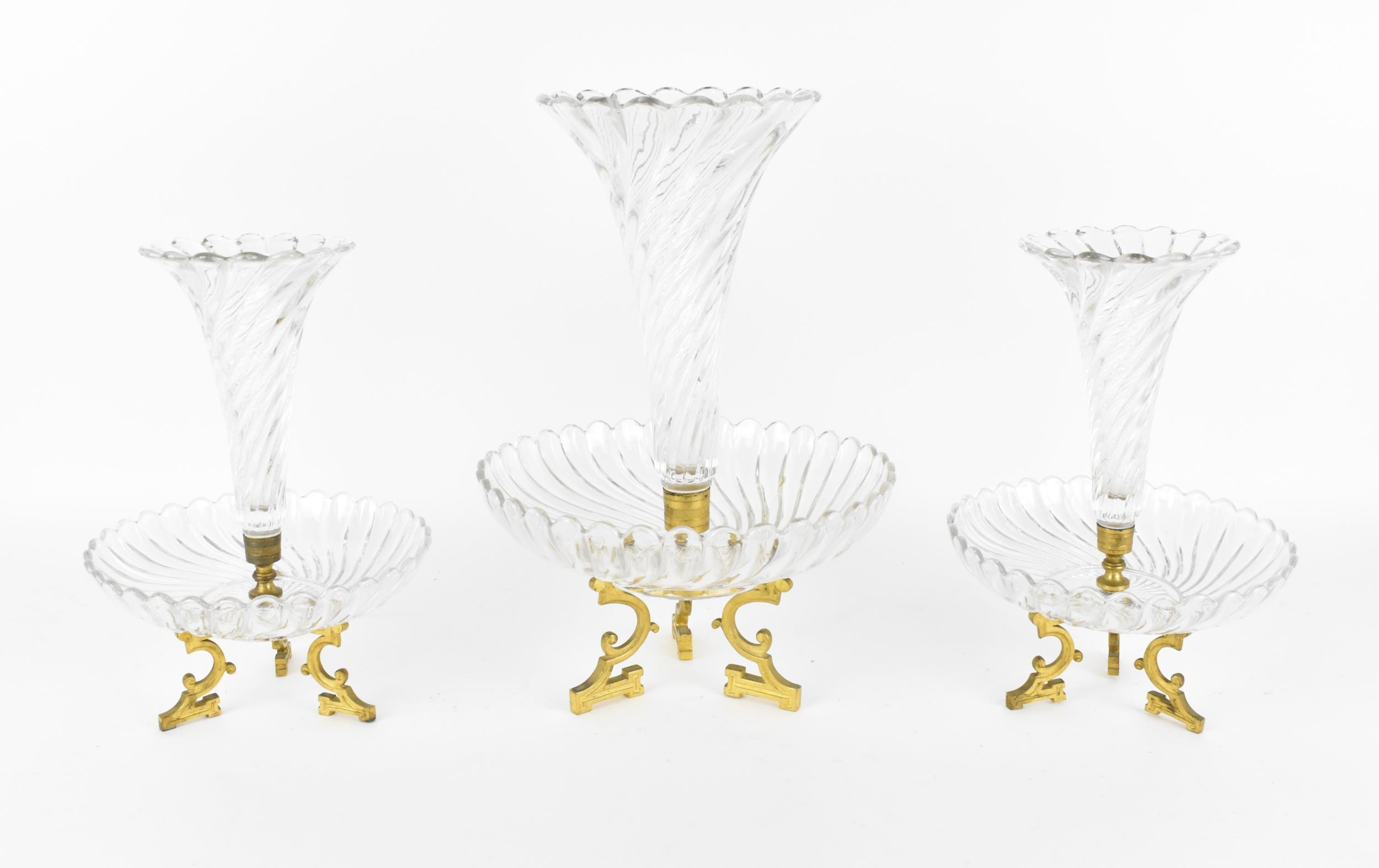 A three-piece Baccarat crystal and ormolu centrepiece, designed as three petal-rimmed trumpet