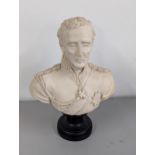 A composition ware bust of Lord Wellington in uniform, on turned black base, Fama Medallion to