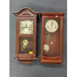 Two reproduction mahogany cased wall hanging clocks to include an 8-day clock striking on five