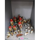 Beswick, Bretby and other model hunting hounds and riders comprising two Beswick riders on ponies, 8