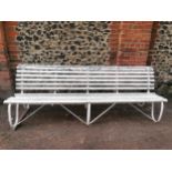 A painted wood and wrought iron slatted garden bench, 87 cm high x 243 cm wide Location: