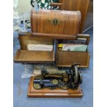 An early 20th century Singer sewing machine, together with a collection of records