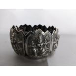 An Indian white metal bowl decorated with seven panels depicting the Hindu deity Sheva in various