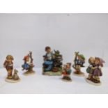 A group of five Goebel Hummel figurines to include the Apple Tree Girl and Boy, Surprise A/F and