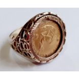 A South African coin inset signet ring in 9ct gold, stamped 375, the ring head mounted with a 1/10