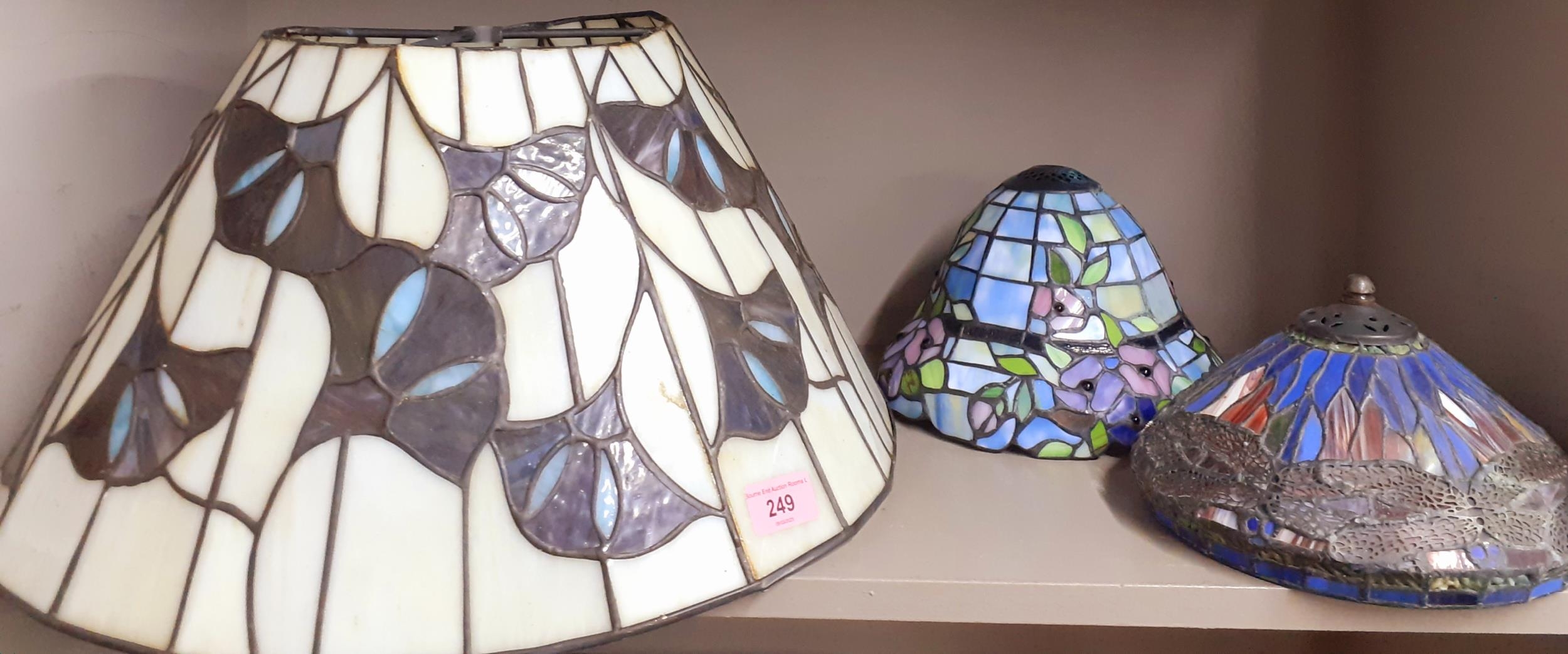 Three Tiffany style decorative glass shades Condition: the larger shade is slightly misshapen -