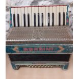An Italian Borsini accordion, 16 buttons with turquoise pearlised decoration together with a