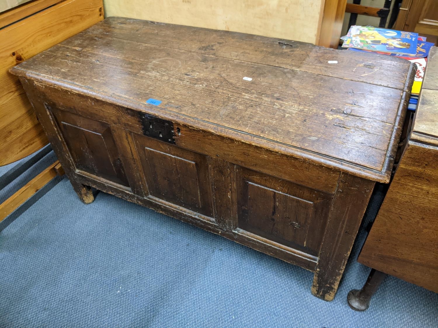 An early 18th century oak panelled coffee having a hinged top and on block shaped legs, 62h x 113h