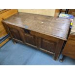 An early 18th century oak panelled coffee having a hinged top and on block shaped legs, 62h x 113h