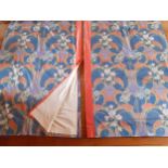 A pair of 1980's Liberty style curtains having swirls of orange hibiscus and pale pink flowers on