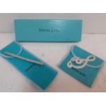 Tiffany-A silver purse ballpoint pen with 'T' clip to the lid, 10cm long together with a silver