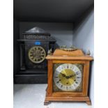 A Victorian black slate mantle clock of classical design with open pillars and frieze above the