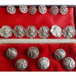 A set of six Edwardian silver circular buttons, each decorated in relief with an amorini by
